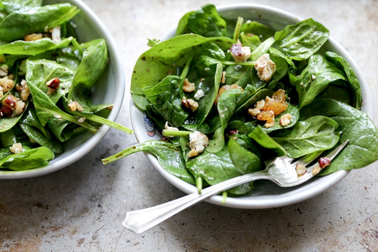 Wilted Spinach Salad with Hazelnuts, Goat Cheese and Raisins Floating