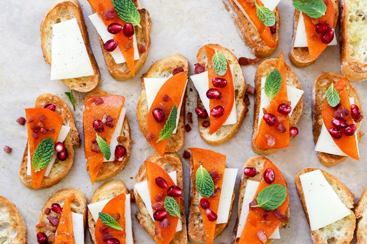 Persimmon Crostini with Manchego, Crispy Pancetta and Pomegranate